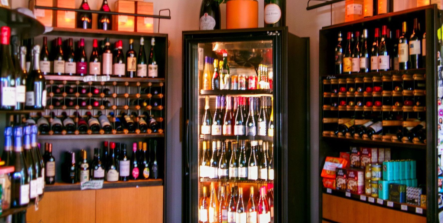Vibrant wine shop interior showcasing assorted wine bottles on shelves.